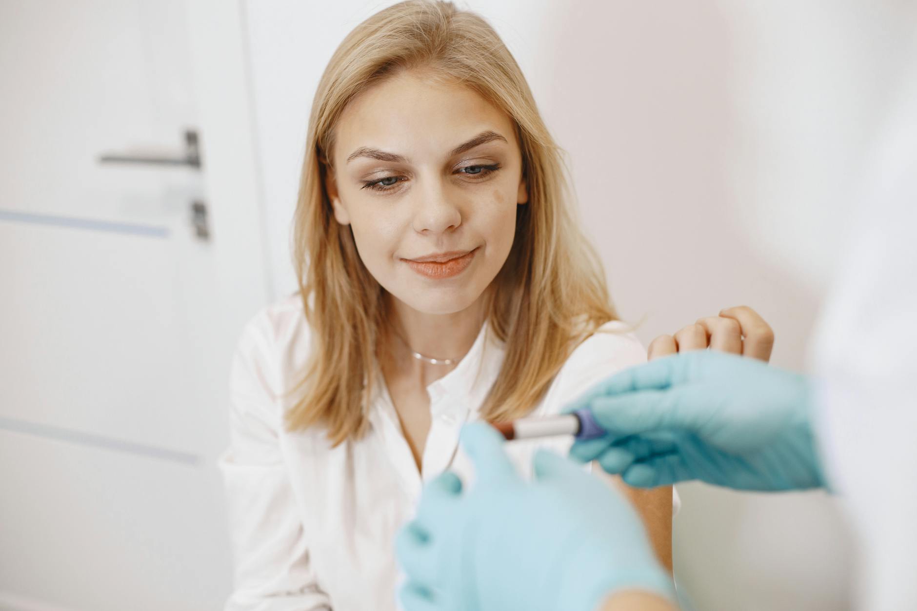 woman looking at a blood sample